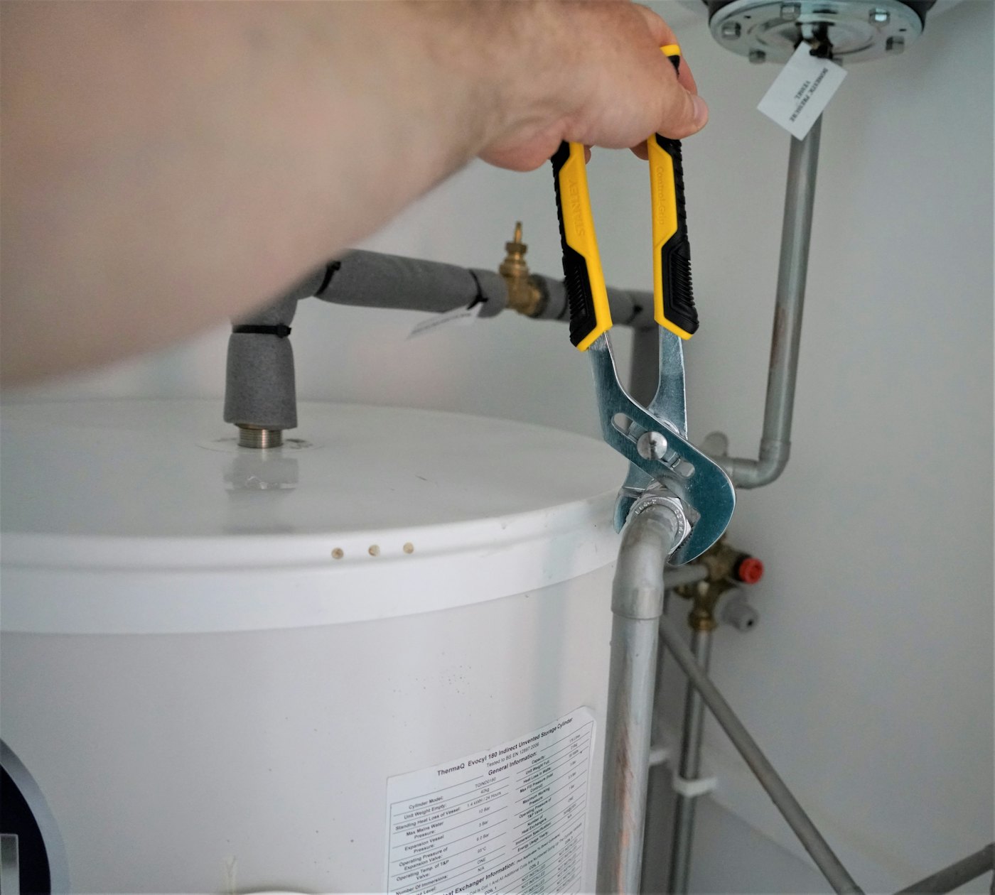 Fitter tightening a pipe fitting during installation